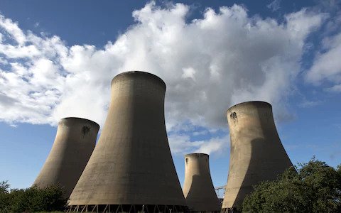 Nuclear power plant during sunset. Dusk landscape with big chimneys.